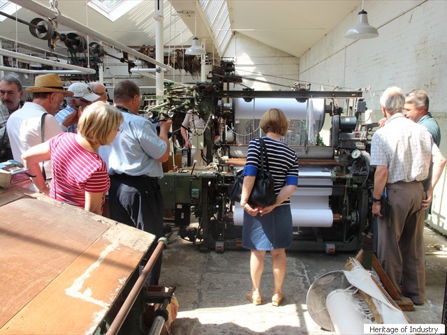 Newcomen members inspect a more modern loom